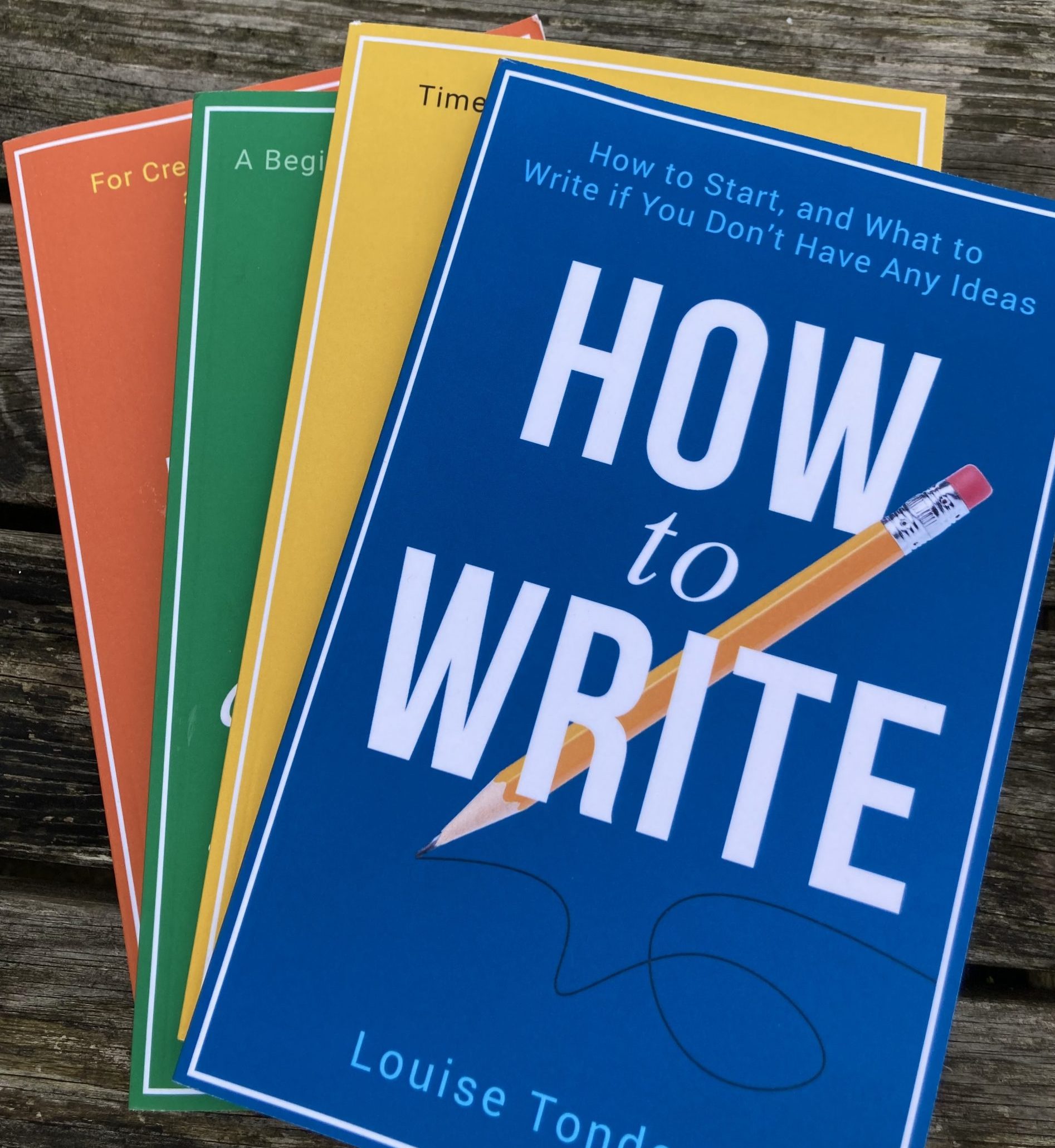 All of the small steps writing guides in a pile outside on the garden table